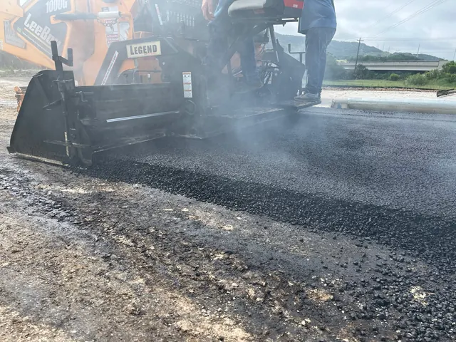 Paving machine laying hot asphalt